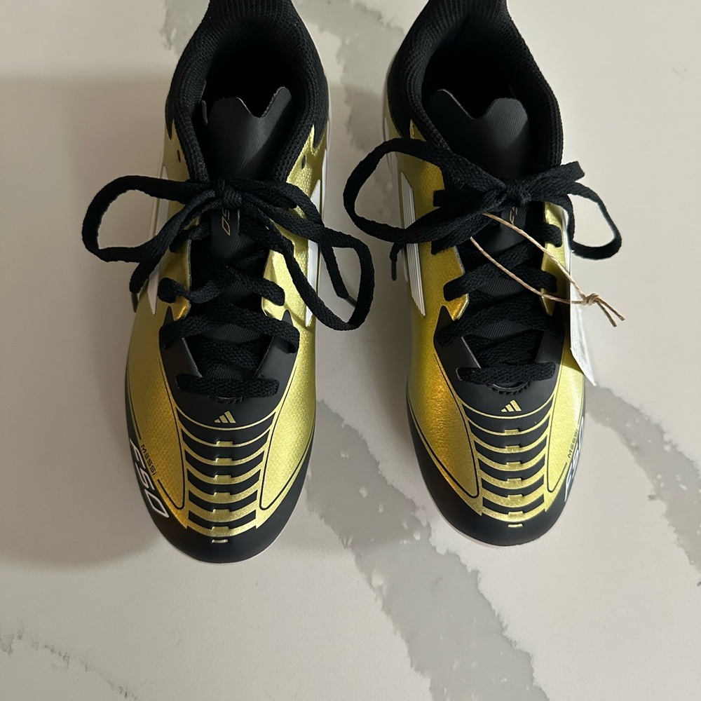 Adidas Kids Gold and Black Cleats for Soccer games.
